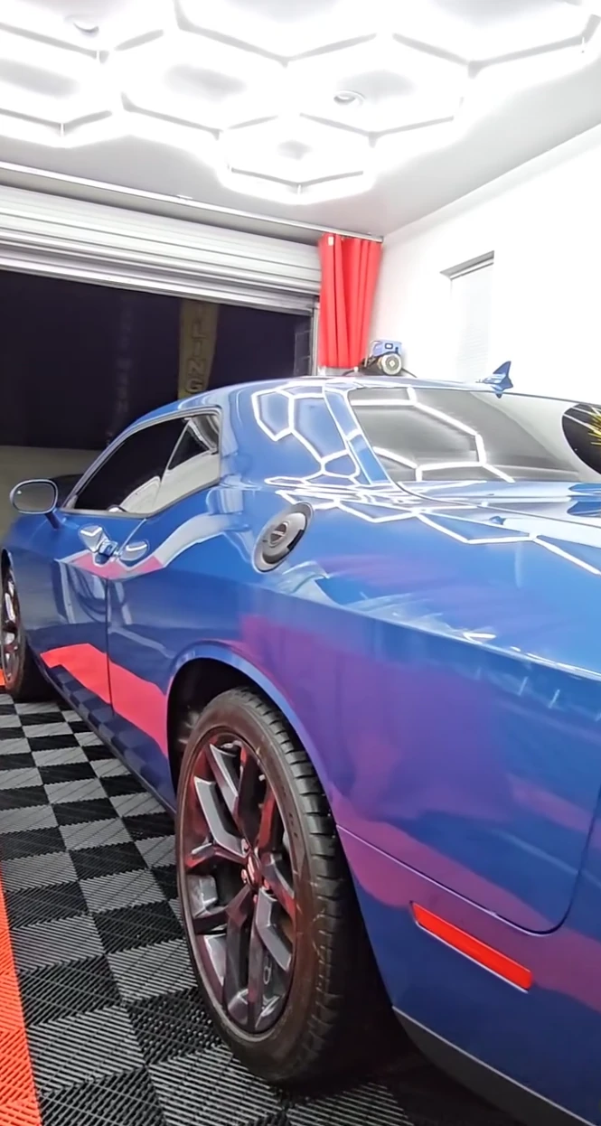Blue Dodge Challenger with a clean glossy finish in the Vanish Auto Tints detailing bay